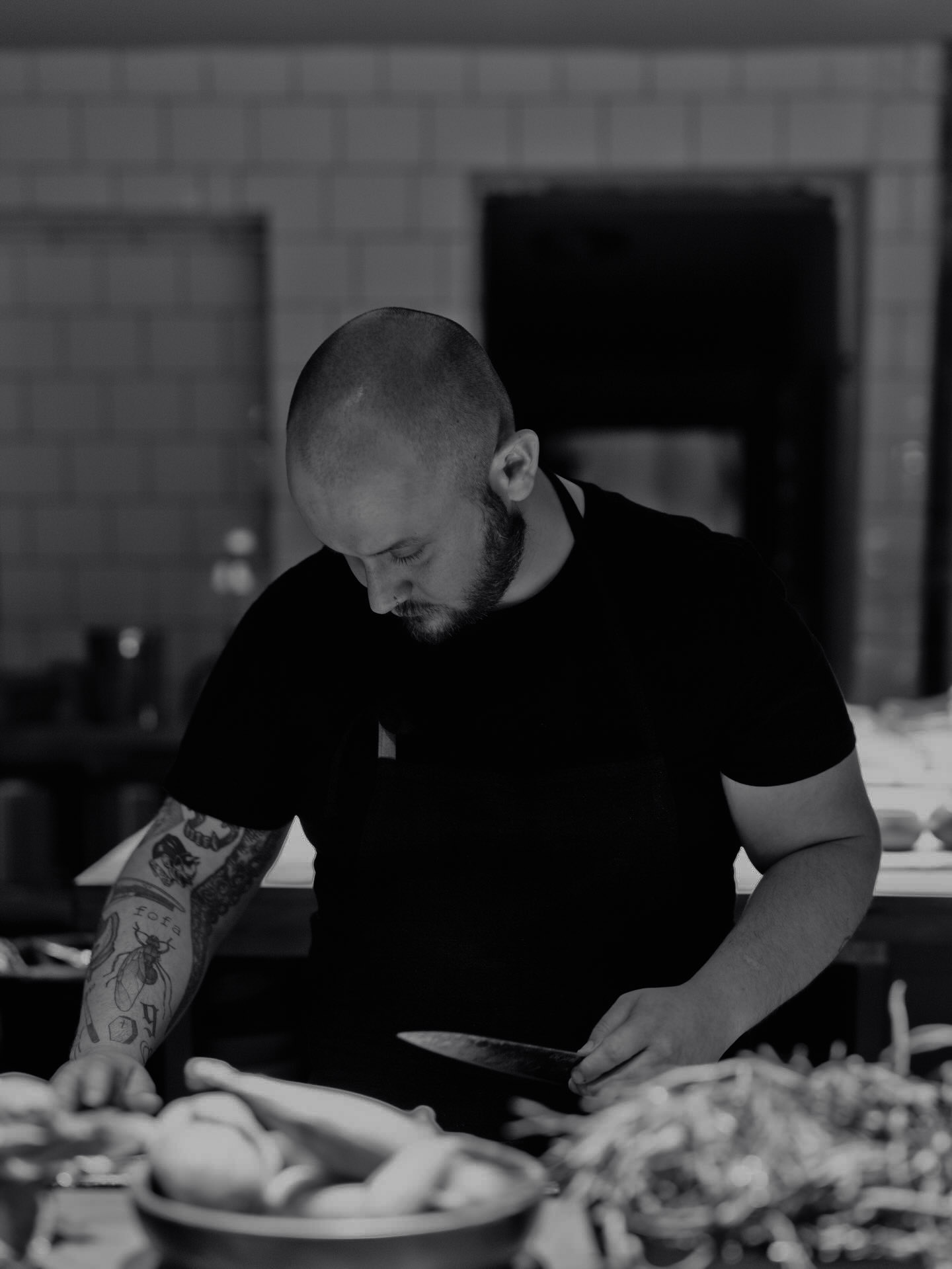 Chef Fidel Caballero plating a dish at the kitchen pass